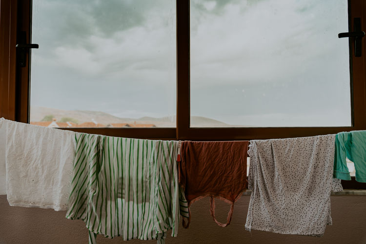Clothes drying on window at home