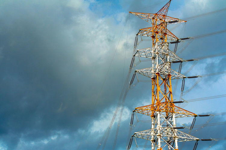 Low angle view of electricity pylon against sky