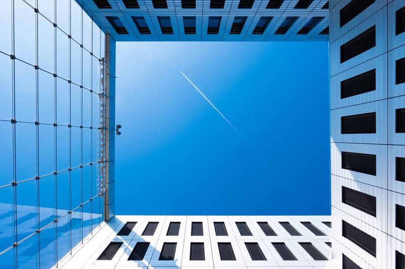 Directly below of building against clear blue sky