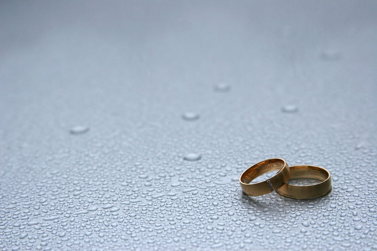 Close-up of wedding rings on floor