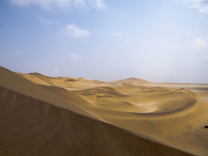 Photograph of a sand dune in the namib desert near swakopmund, namibia on a sunny dry season morning