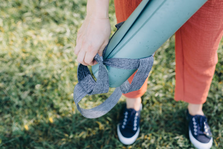 High angle view of woman holding an exercise mat 