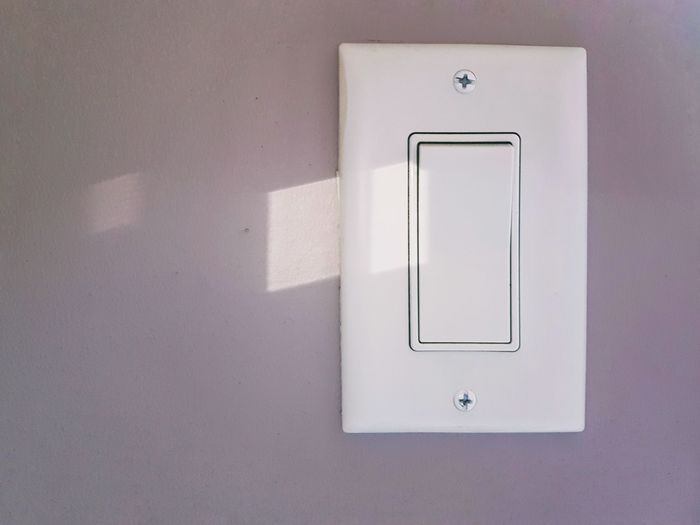 Close-up of light switch on wall