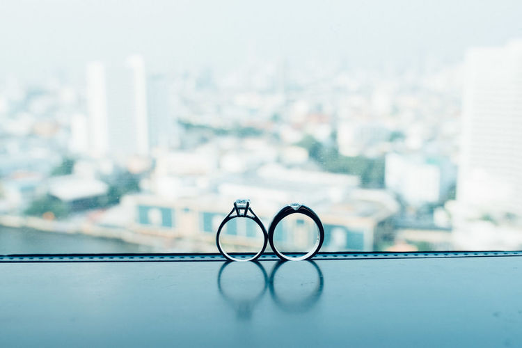 Close-up of wedding rings on window