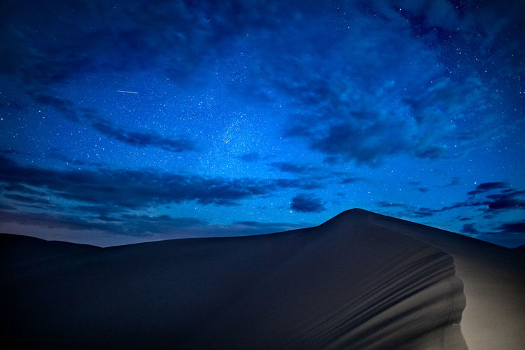 Low angle view of desert against sky at night