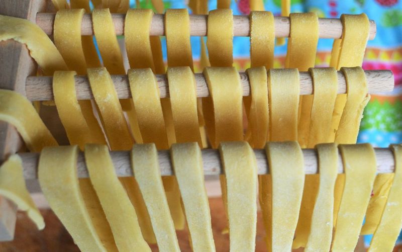 High angle view of raw spaghetti on wooden rods