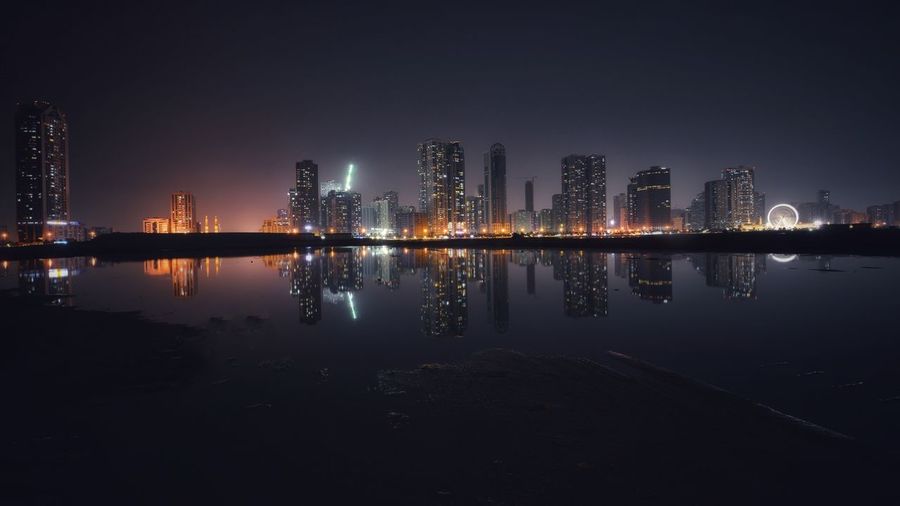 Reflection of buildings in city at night