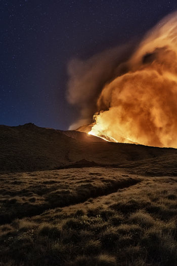 Scenic view of lava against sky at night