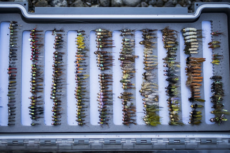 Full tackle box of fly fishing flies in washington river