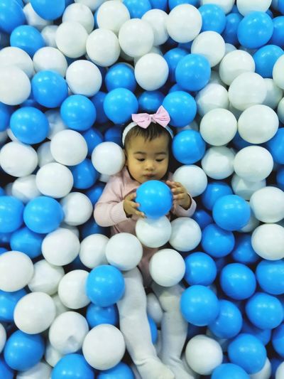 High angle view of girl in ball pool