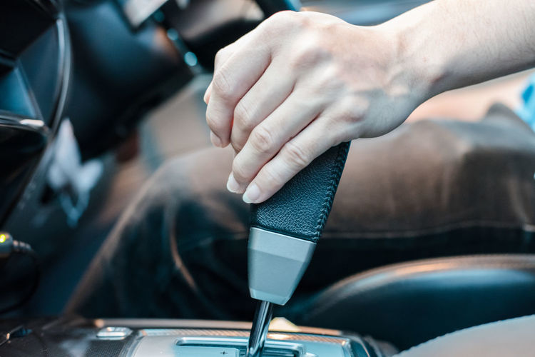 Midsection of man driving car
