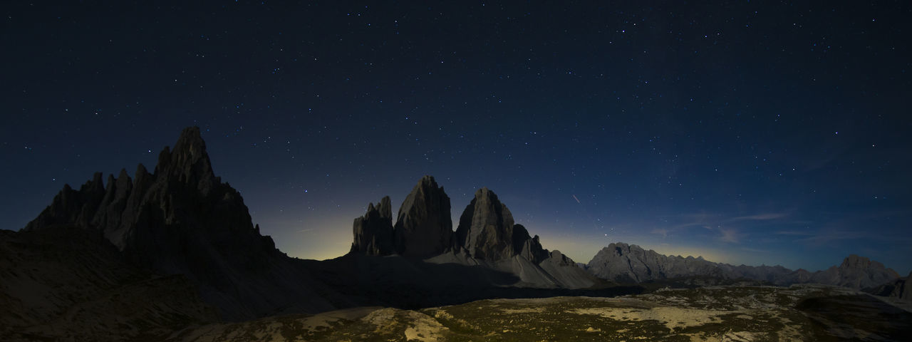 Tre cime di lavaredo panorama at night under starry sky - sesto dolomites
