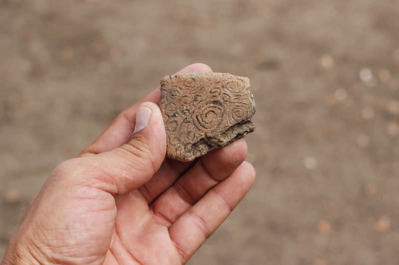 Prehistoric cult ceramic artifact held in hand