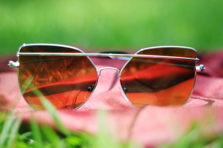 Close-up of sunglasses with reflection on fabric