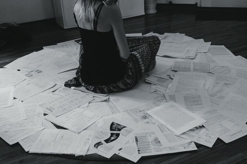 Hopeless woman surrounded by paperwork