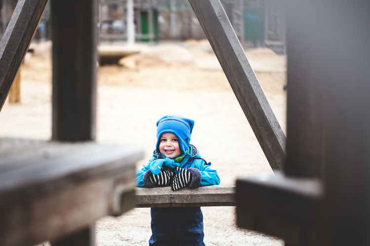 Portrait of boy in playground during winter