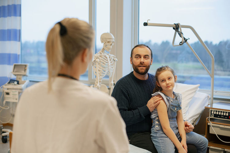 Father with daughter in examination room