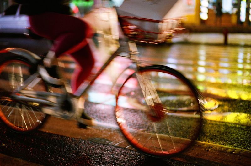 Blurred motion of man riding bicycle on street