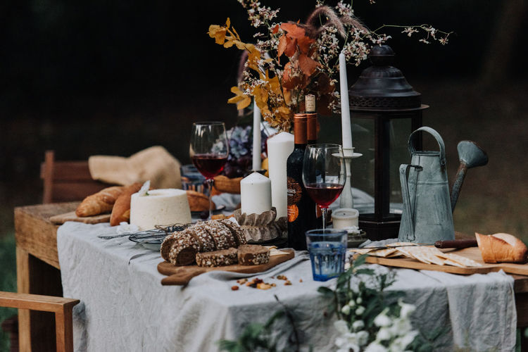 Food and drink with flowers on table in yard