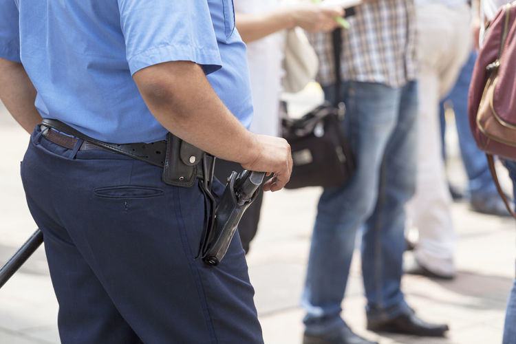 Midsection of policeman