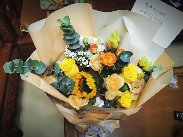 High angle view of various flowers in vase on table