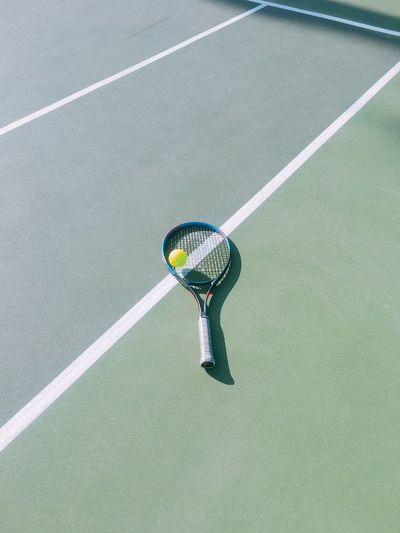 High angle view of tennis racket on court 