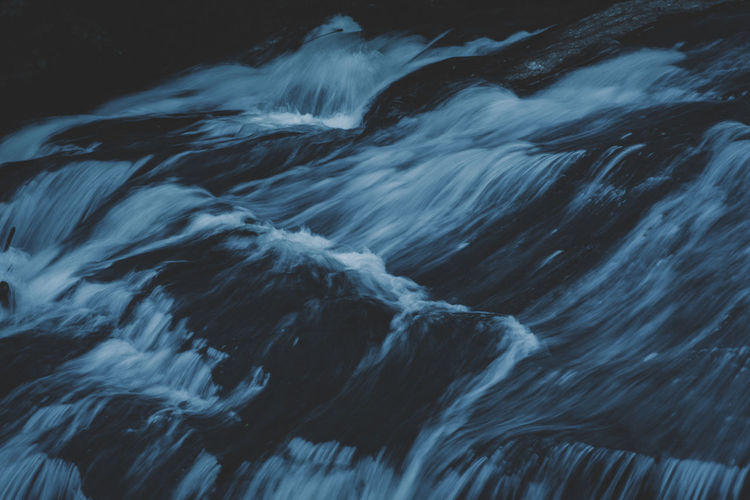 Close-up of water flowing over sea
