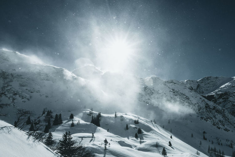 Scenic view of snowcapped mountains against sky at night