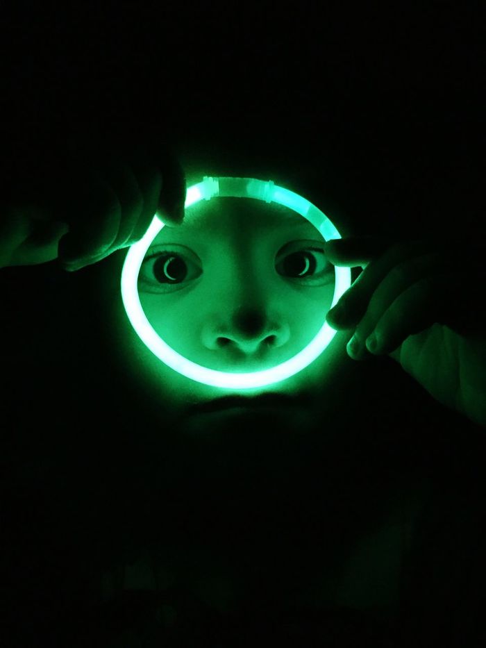 Close-up of boy holding illuminated glow ring