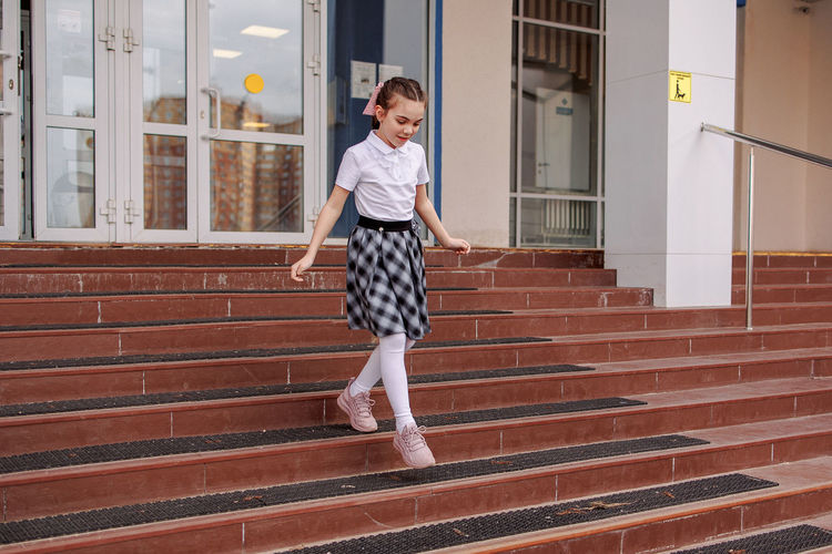 Back to school. girl in school uniform go to school. beginning of lessons. first day of autumn. 