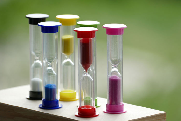 Close-up of multi colored hourglass on table