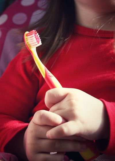 Close-up of girl holding toothbrush