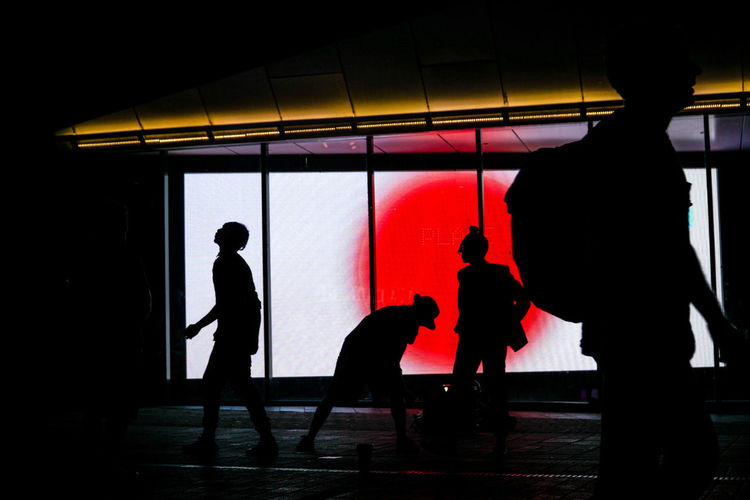 Silhouette men standing in corridor