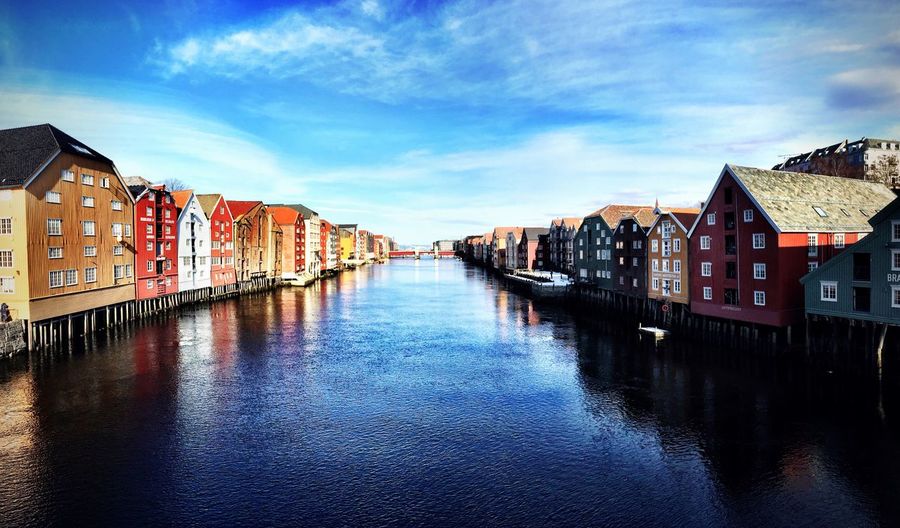 Scenic view of nidelva river amidst houses in city