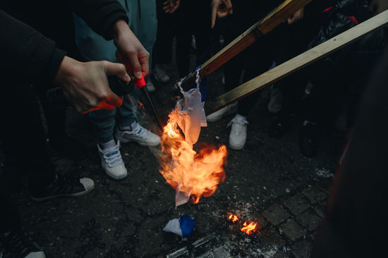 Low section of people holding fire