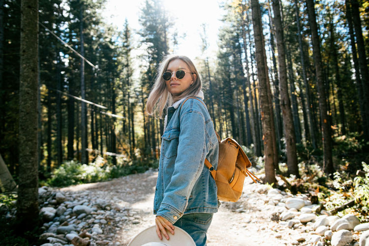 Woman wearing sunglasses in forest