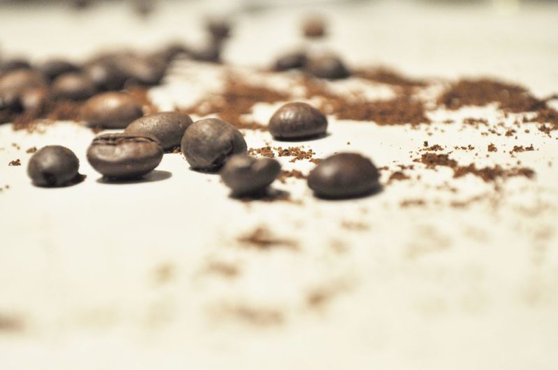 Close-up of coffee beans on sand