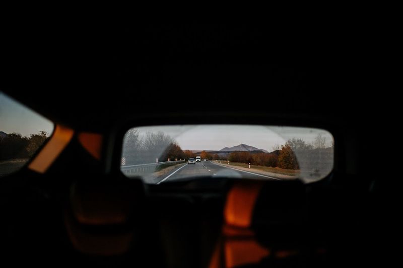 Reflection of road in rear view mirror