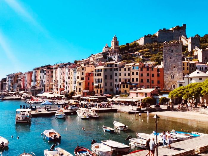 Boats in sea against buildings in city