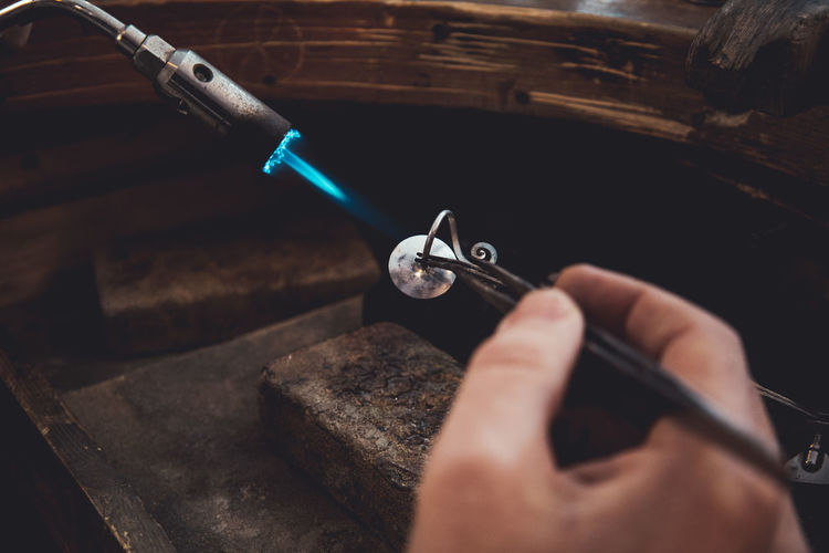 Close-up of man working on metal