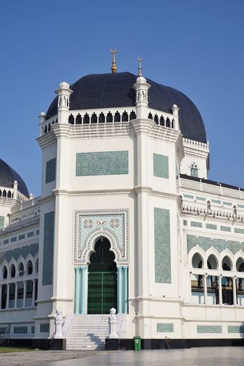 Low angle view of historical building ' masjid raya al mashun medan ' against blue sky