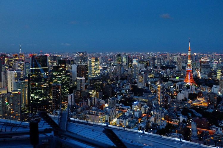 Illuminated cityscape against sky