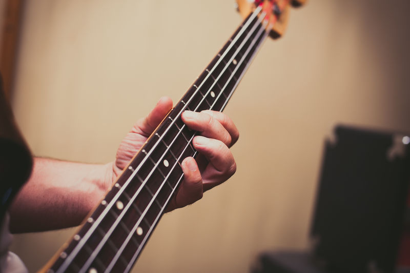 Cropped image of hand playing guitar