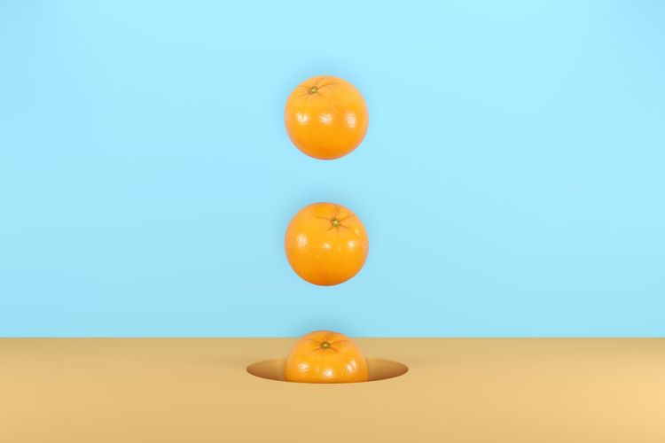 Digital composite image of orange over colored background