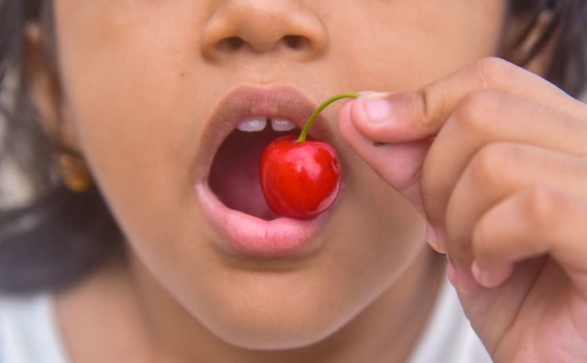 Close-up of girl eating fruit