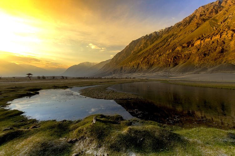 Scenic view of lake against sky during sunset