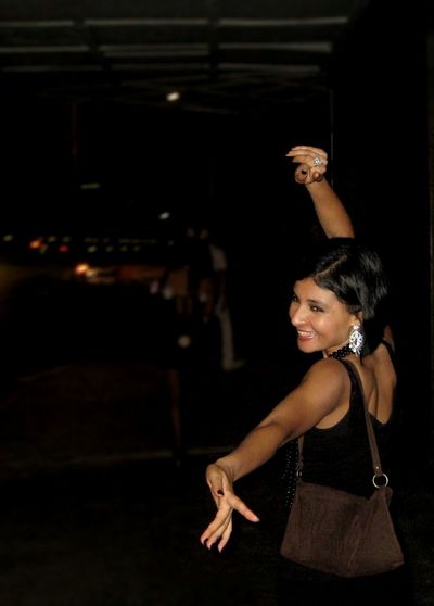 Young woman standing at night