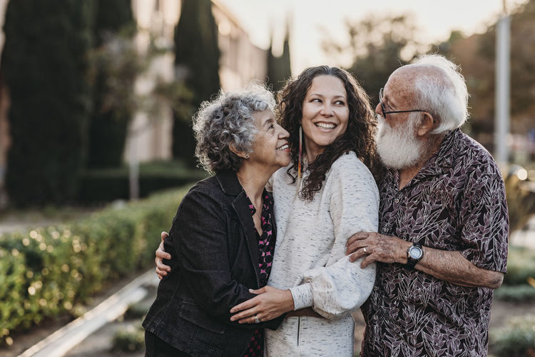 Lifestyle portrait of active senior married couple and adult daughter