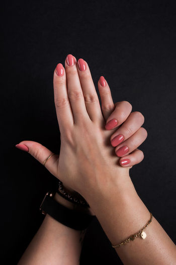 Close-up of woman hand over black background
