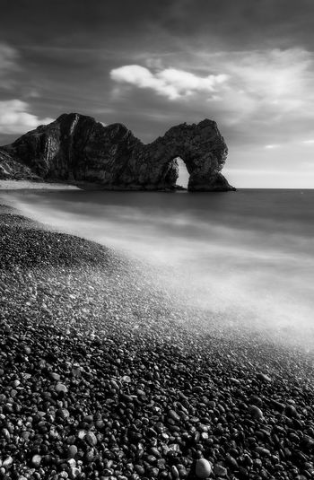 The durdle door landmark beach in the uk in black and white